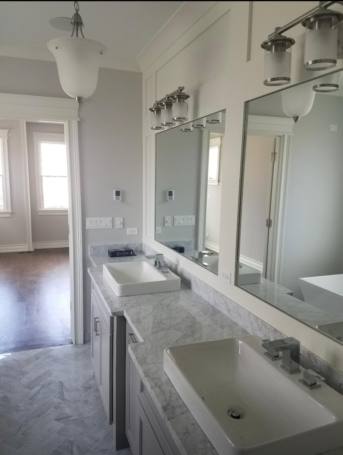 Classic double vanity with framed mirrors and marble countertops — elegant master bathroom
