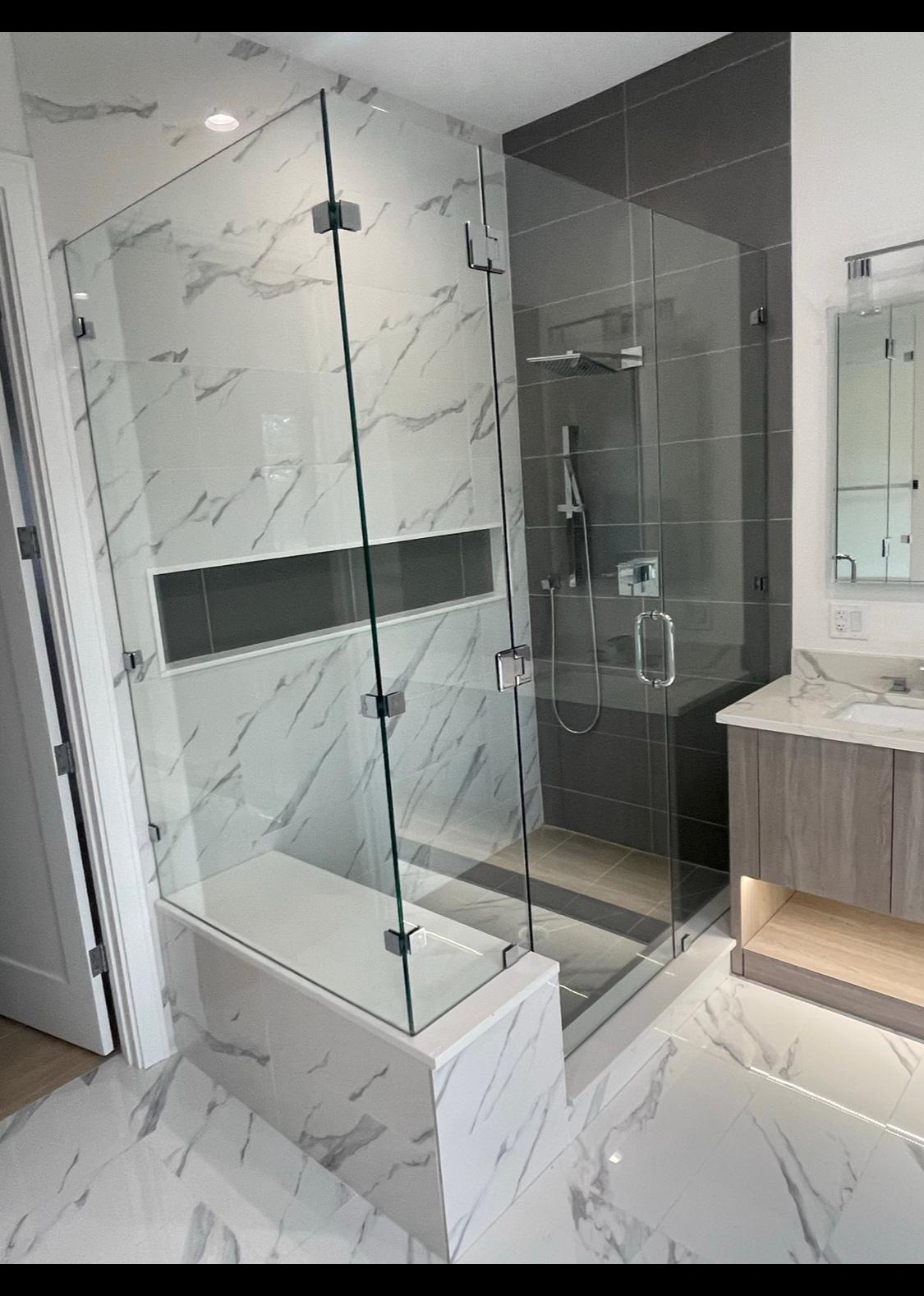 Marble-clad shower with full glass enclosure