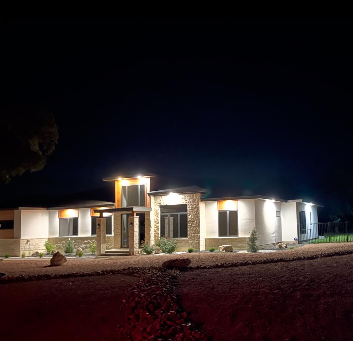 Custom luxury home illuminated at dusk