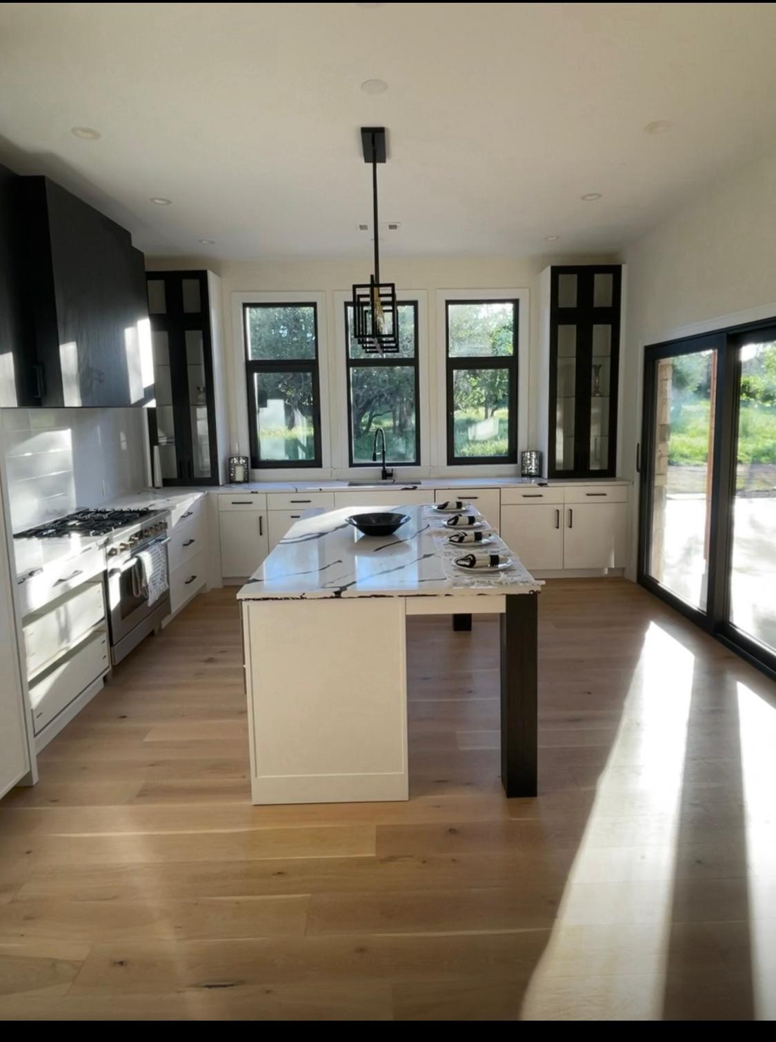Oversized marble waterfall island in modern kitchen